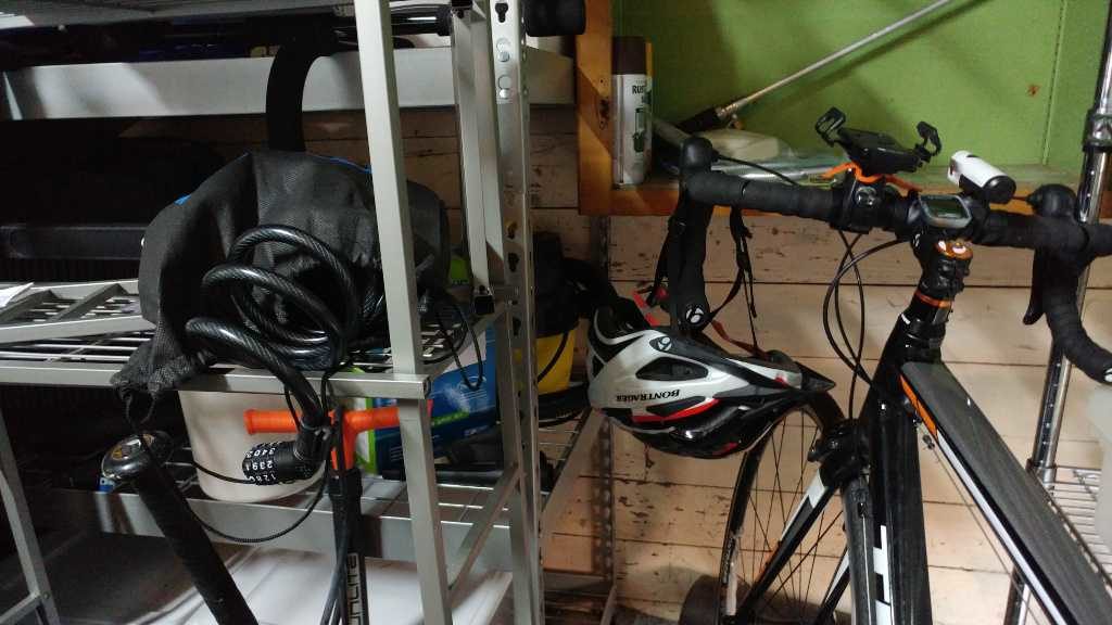Drawstring bag with cable lock next to bike