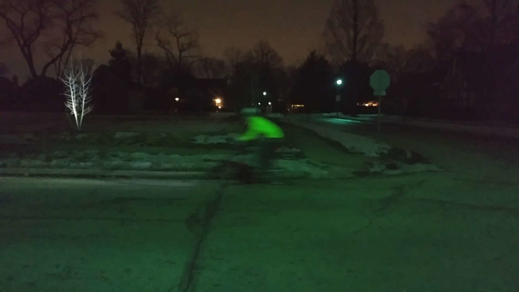 blurry rider at night far